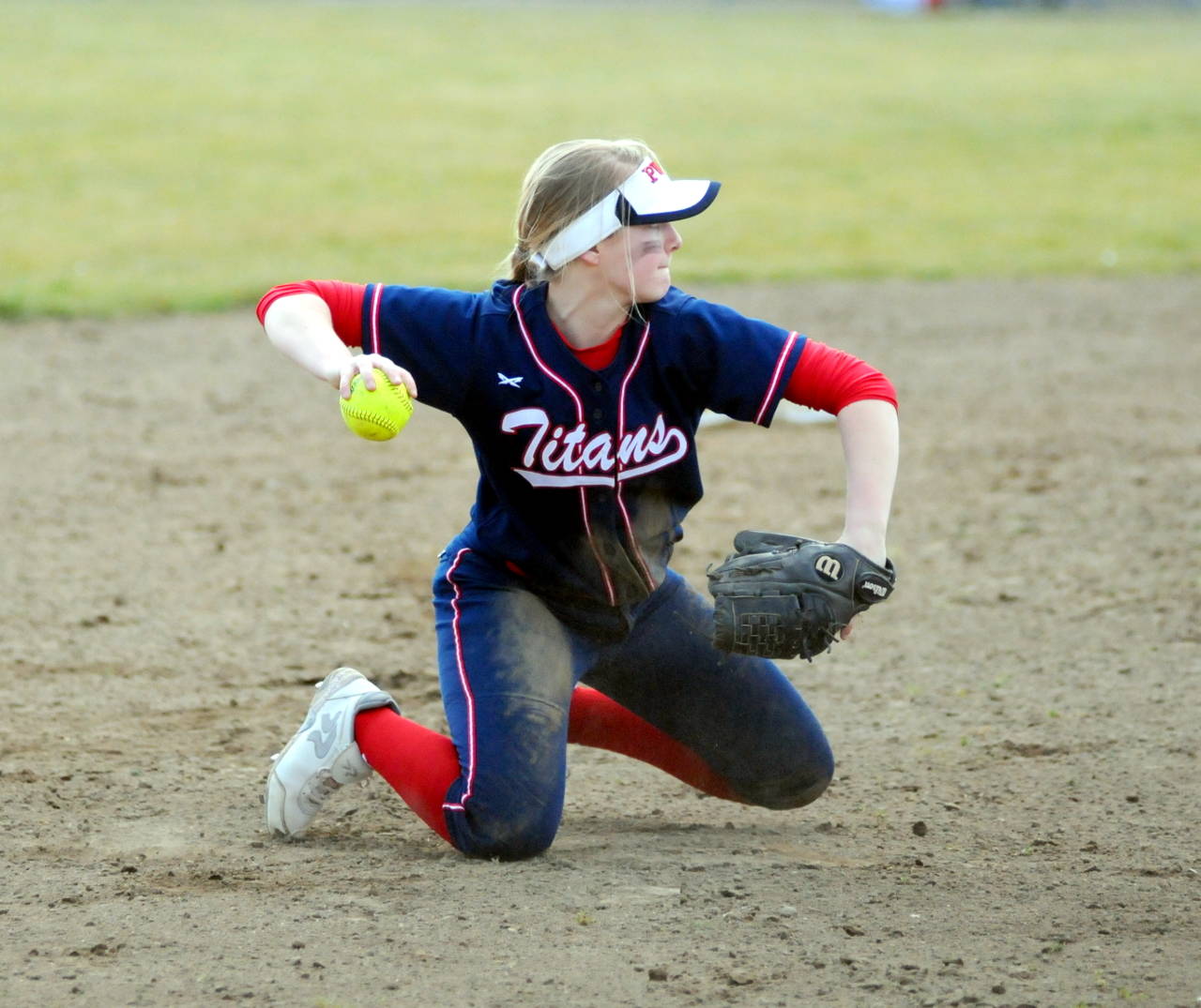 PWV third baseman Katie Adkins throws from her knees after making a diving stop in the first game of a doubleheader against Ocosta on Saturday. (Ryan Sparks | Grays Harbor News Group)