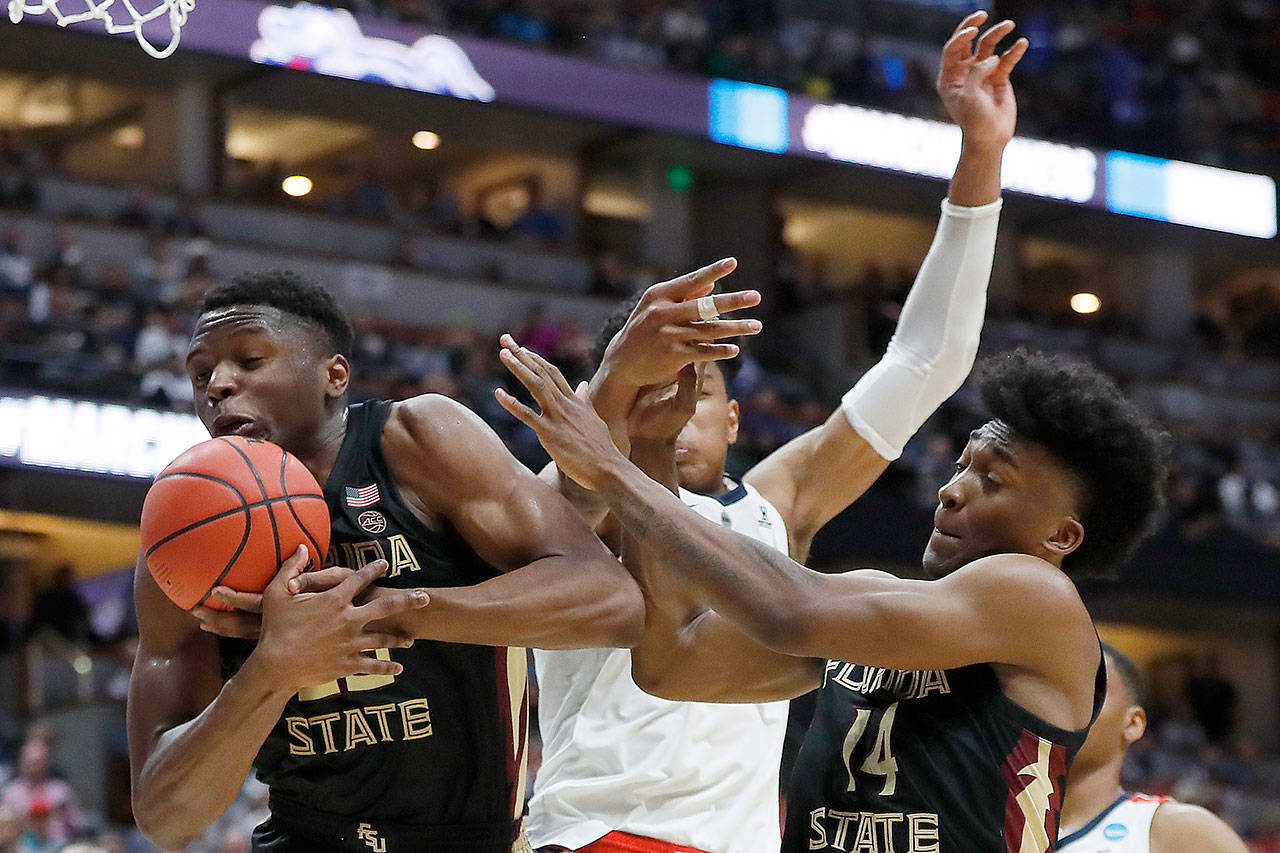 Florida State’s Mfiondu Kabengele (25) and Terance Mann (14) of the Florida State Seminoles fight for the rebound against Gonzaga’s Rui Hachimura during the 2019 NCAA Men’s Basketball Tournament West Regional on Thursday. (Sean M. Haffey/Getty Images/TNS)