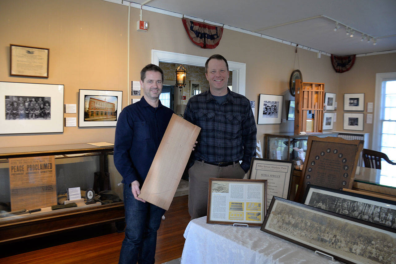 Louis Krauss | Grays Harbor News Group                                Australian Professor Chris Gibson, left, stands with Polson Museum Director John Larson holding wood from the Posey Manufacturing Co. for a guitar soundboard.