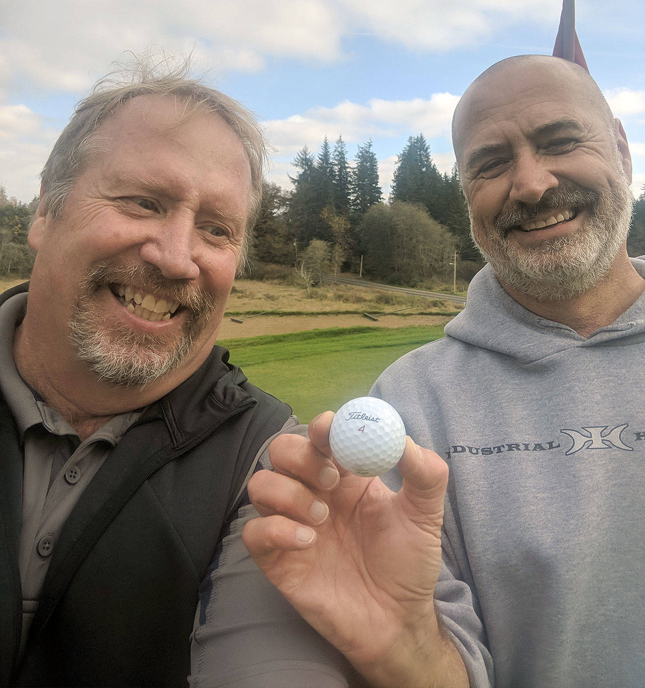 Pat Gouchner, right, is all smiles after hitting a hole-in-one on the No. 7 hole at Grays Harbor Country Club on Friday. Gouchner’s ace was witnessed by Rick Moore, left. (Submitted Photo)