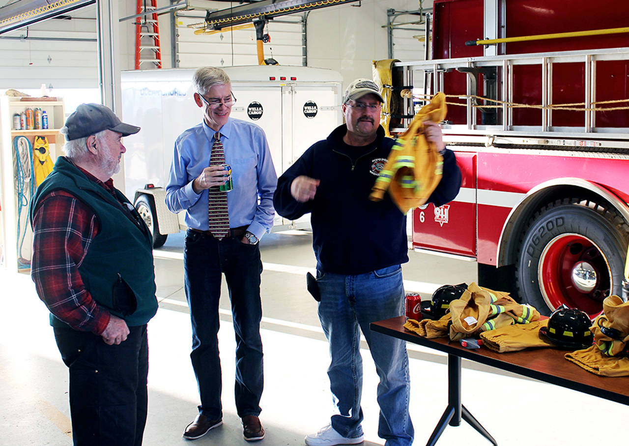 At the Fire Department Open House last year, Mike Thuirer, far right, talks with Tom Kimzey and Mike McGregor.