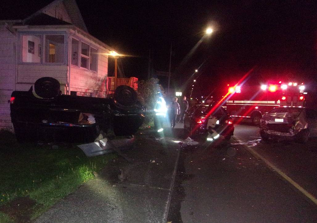 (Aberdeen Police photo) Aberdeen police investigate a crash early Saturday morning. Two parked cars and a house were damaged by the driver’s car. The driver was seen at Grays Harbor Community Hospital and released.
