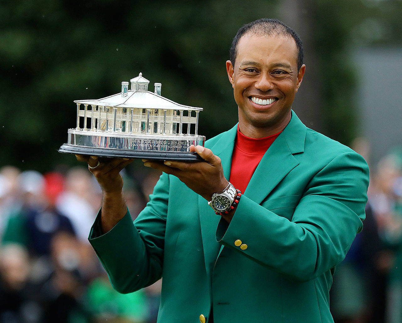 Tiger Woods holds the trophy after being presented the green jacket for winning the Masters at Augusta National Golf Club on Sunday, April 14, 2019, in Augusta, Ga. (Curtis Compton/Atlanta Journal-Constitution/TNS)