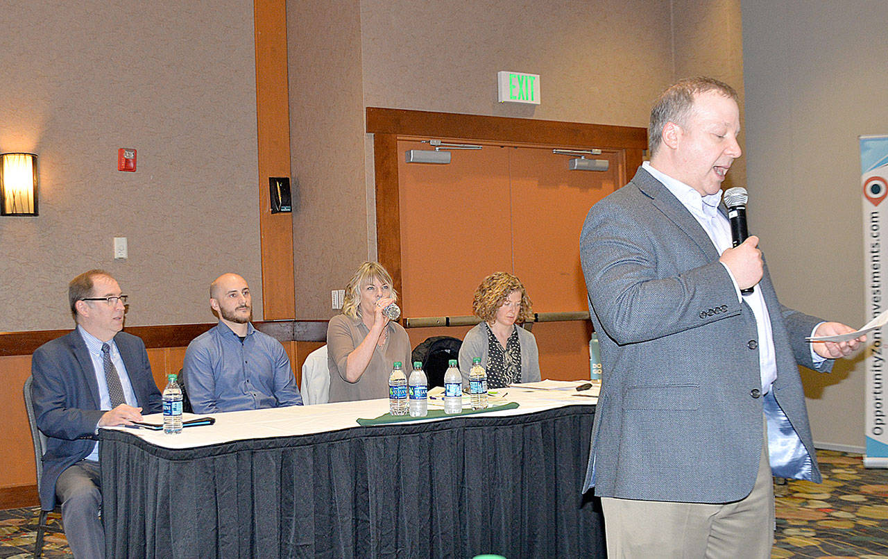 DAN HAMMOCK | GRAYS HARBOR NEWS GROUP                                Dru Garson, CEO of Greater Grays Harbor Inc., right, introduces the panel at the opportunity zones presentation in Ocean Shores April 11. From left: Craig Nolte, Federal Reserve Bank of San Francisco; Kyle Wise, Thurston County Economic Development Council; Julie Knott, Clallam County Economic Development Council; and Melissa LaFayette, National Development Council.