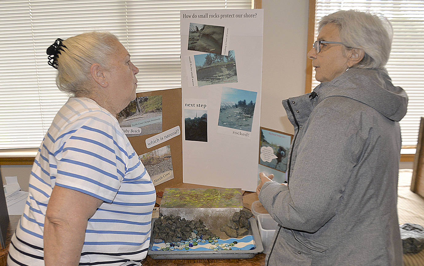 DAN HAMMOCK | GRAYS HARBOR NEWS GROUP                                Clare Conlan, left, Master of North Willapa Harbor Grange, explains how dynamic revetment protects shorelines from erosion with the help of an interactive model.