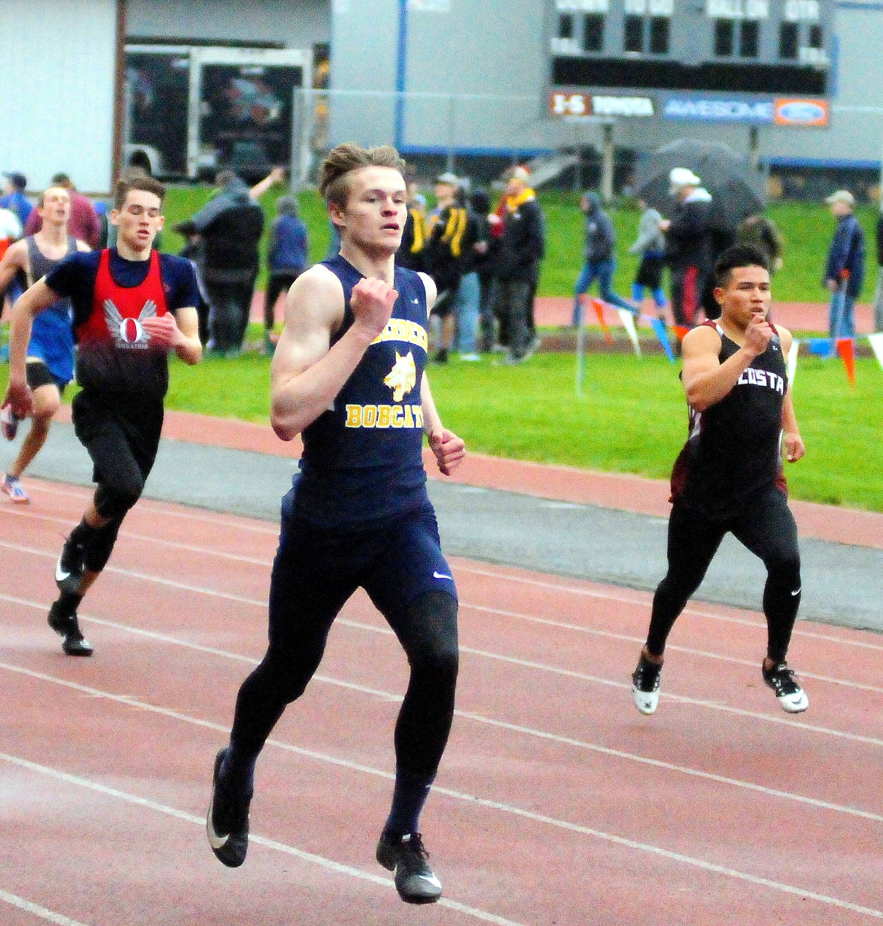Aberdeen’s Wyatt Johnson, center, pulls ahead and wins the 400 meters at the Chehalis Activators meet on Friday. Johnson advanced to Saturday’s finals with a time of 53.95. (Hasani Grayson | Grays Harbor News Group)
