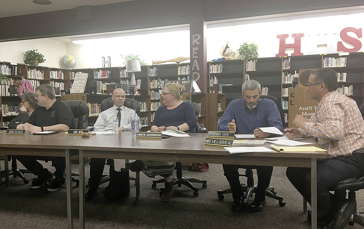 DAN HAMMOCK | GRAYS HARBOR NEWS GROUP Members of the Hoquiam School Board converse prior to Tuesdays special meeting. Later, they would vote 4-1 to approve a resolution calling for the reduction of 19 district positions as a way to deal with a $2 million budget deficit in the 2019-20 school year.