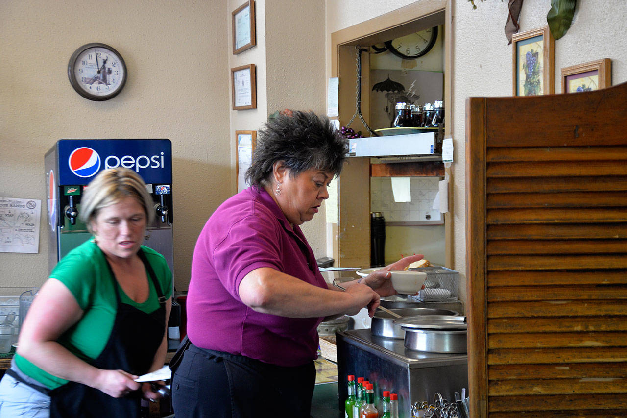 (Louis Krauss | Grays Harbor News Group) Anne Marie Babineau, right, is both the founder and works as a waitress at Anne Marie’s Cafe in Aberdeen, which closes Saturday following her retirement.