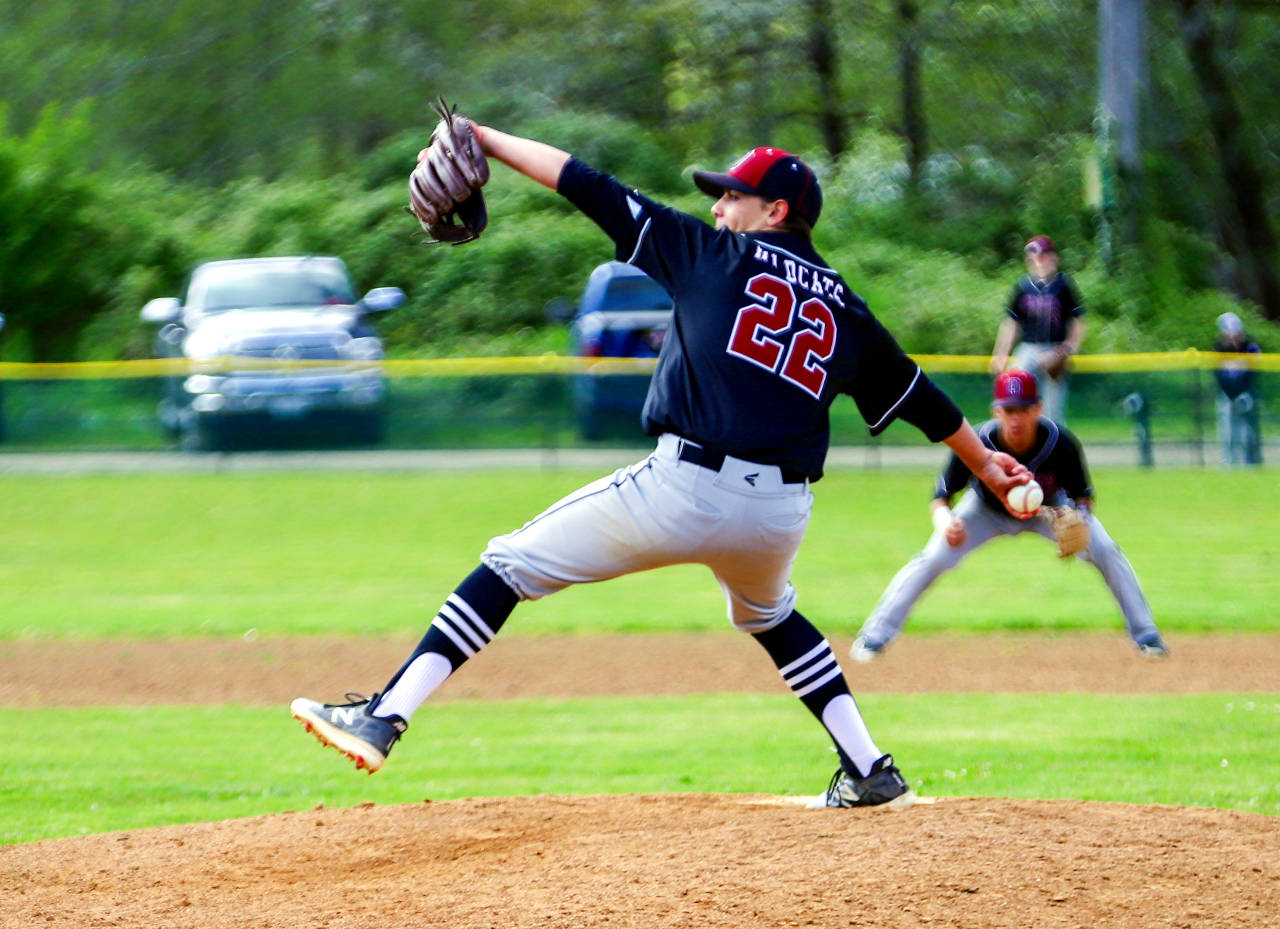 Ocosta junior Cole Hatton throws a pitch during Saturdays doubleheader sweep over Raymond. Hatton earned wins in both games as the Wildcats clinched their third straight 2B Pacific League title. (Photo by Larry Bale)