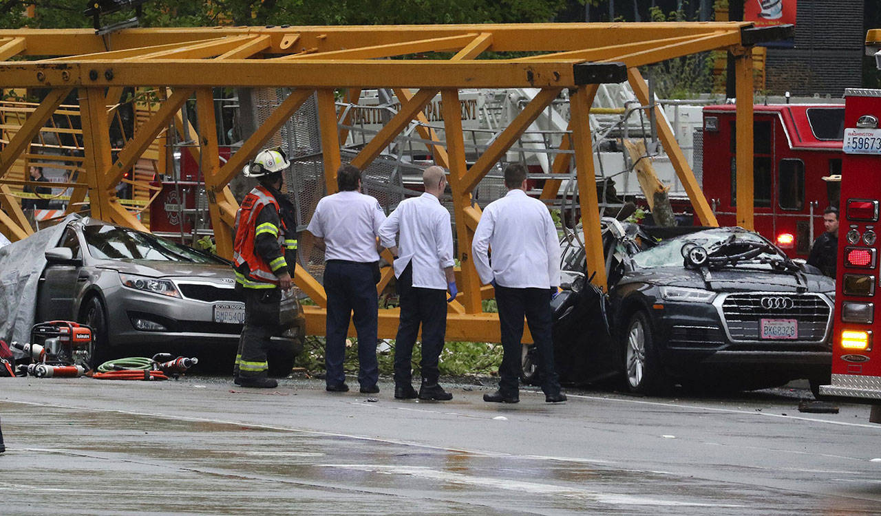 Emergency crews investigate the scene of a collapsed crane at Fairview Avenue North and Mercer Street in Seattle’s South Lake Union neighborhood on Saturday. (Alan Berner/Seattle Times)