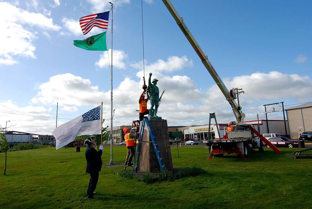 Courtesy Thorin Sprandel                                Construction workers use a crane to reinstall the Doughboy statue at Zelasko Park in Aberdeen Wednesday morning after it was repaired.