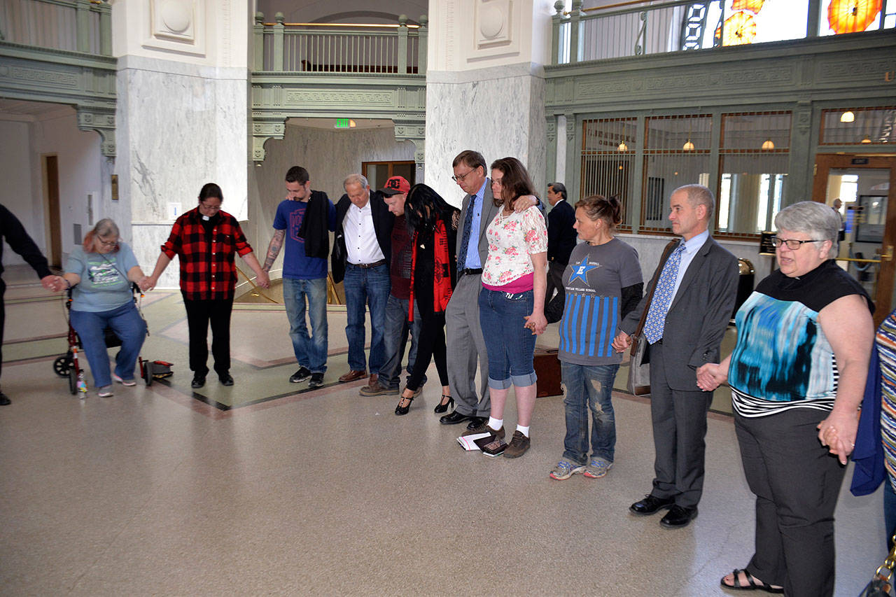 (Louis Krauss | Grays Harbor News Group) The attorneys and several plaintiffs involved in a federal lawsuit against the City of Aberdeen to stop its homeless evictions, as well as other supporters, hold a prayer after the hearing in Tacoma Tuesday.