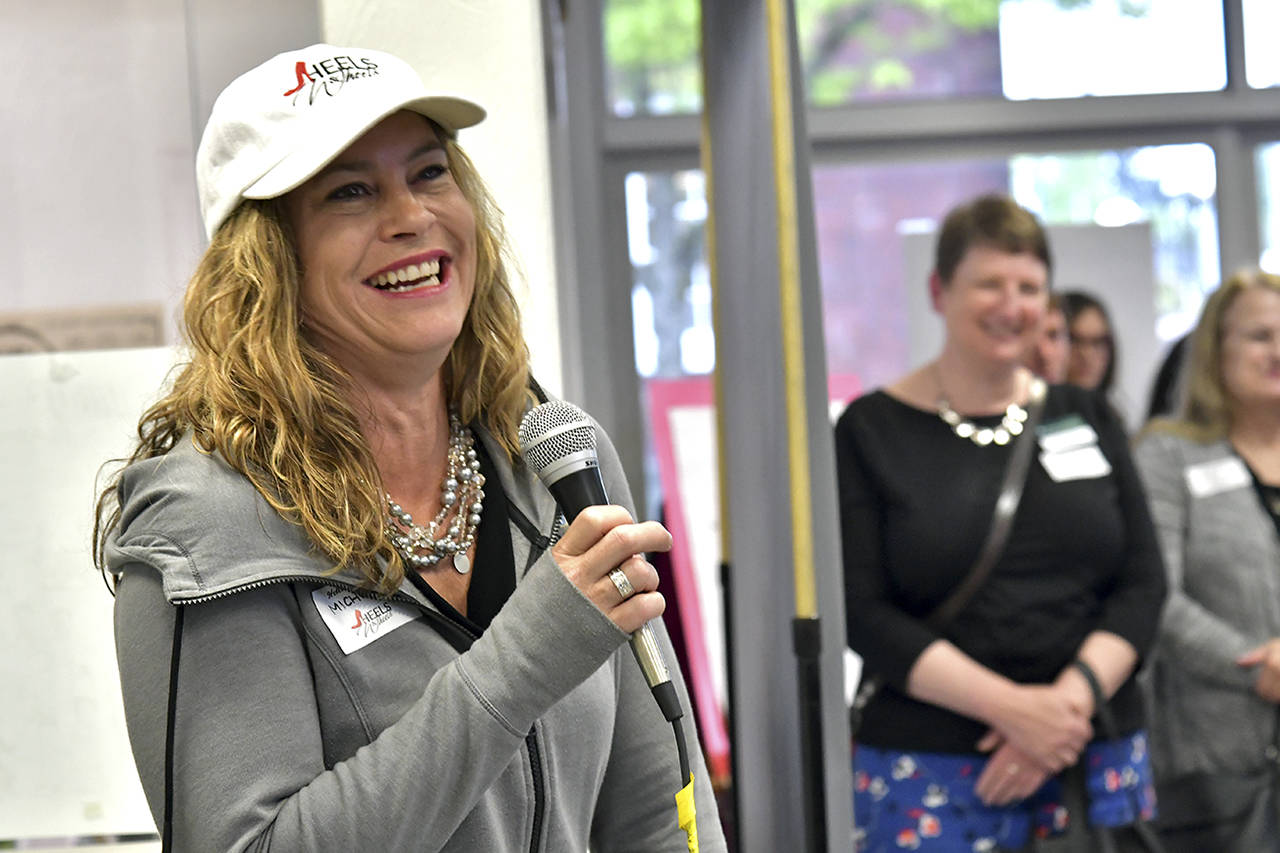 Darrell Westmoreland                                Host Michelle Glick welcomes women from all around the Harbor to Heels on Wheels, held Thursday in the Whitney’s Chevrolet showroom.