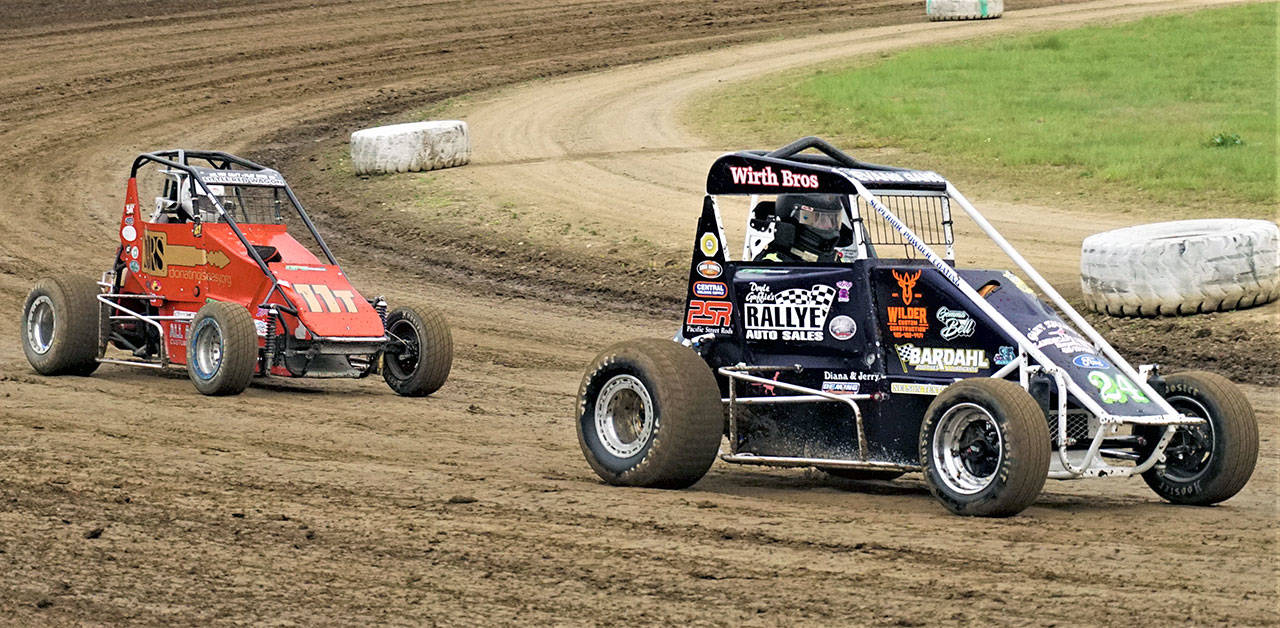 Ray Stebbins (11t) and Nick Evans (24) race their midget cars during the Northwest Focus Midget Series on Saturday at Grays Harbor Raceway. (Photo by AR Racing Videos)
