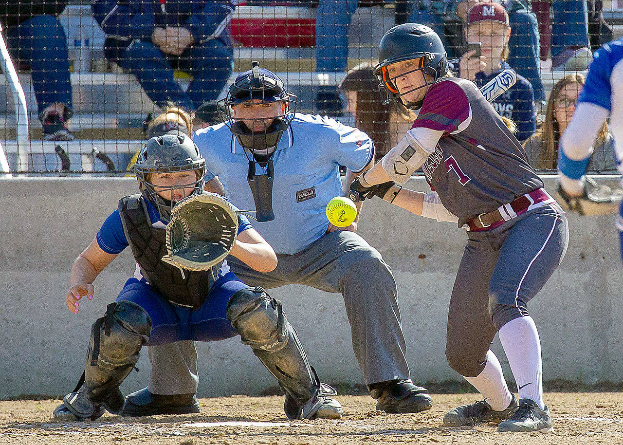 Montesano’s Katie Granstrom and Elma catcher Olivia Cain follow a pitch during a game on April 24. Both the Bulldogs and Eagles begin play in the 1A State Softball Tournament at 10 a.m. on Friday. (Photo by Shawn Donnelly)