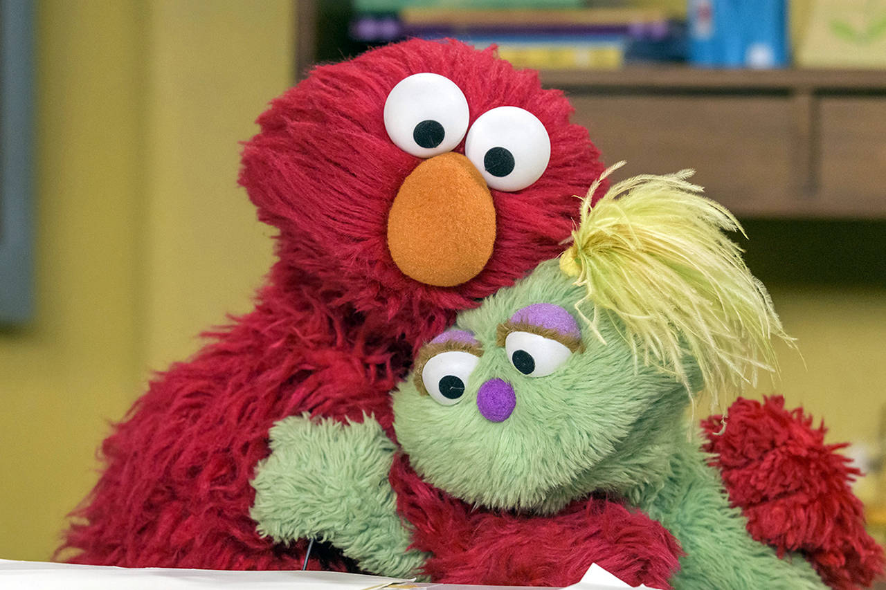 Sesame Workshop                                Elmo, left, hugs Karli, the new Muppet on the long-running PBS children’s show “Sesame Street.”