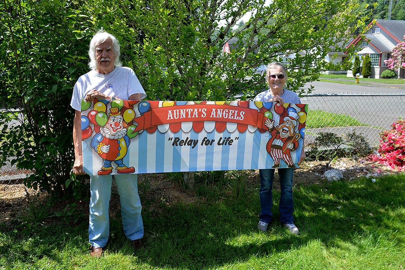 Louis Krauss | Grays Harbor News Group                                Diane Dea’s parents, Lawrence (“Lamb”) and Jackie Oliver, hold up their 2019 “Aunta’s Angels” sign for this year’s Relay for Life.