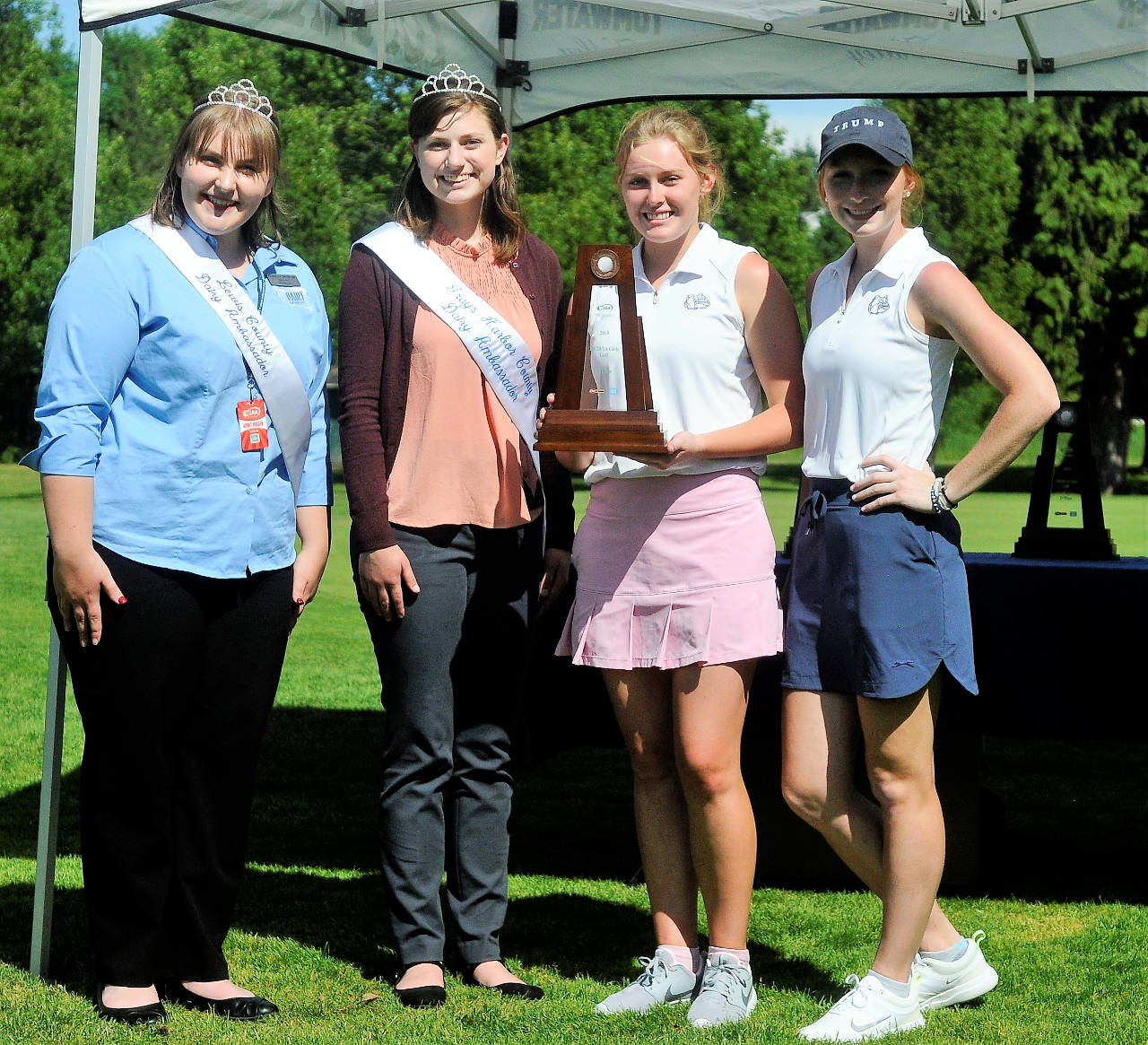 From left: WIAA Diary Farmers Ambassadors Natalie Dolman and Gabby Brockway, pose with Montesano golfers Mylaina Parker and Glory Grubb after the Bulldogs finished in fourth place at the 1A State Tournament in Tumwater on Wednesday. (Hasani Grayson | Grays Harbor News Group)