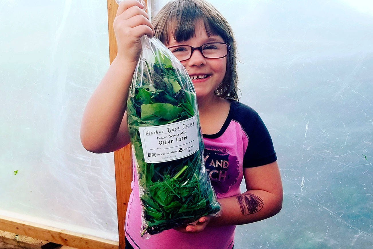 Courtesy Harbor Eden Farms                                Ares Ross, daughter of the owners of Harbor Eden Farms which will be at this Sundays Aberdeen farmers market, holds up a bag of the farms Power Greens mix.