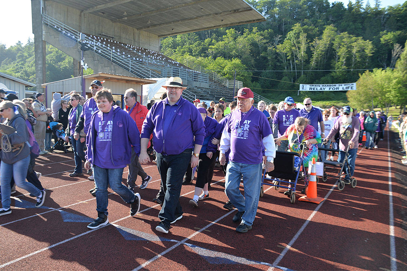 (Louis Krauss | Grays Harbor News Group) Attendees at the Relay For Life Grays Harbor event make their first lap around the track Friday afternoon.