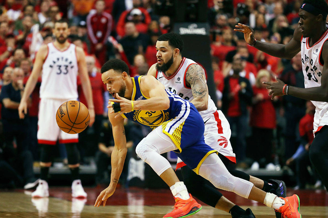 Golden State’s Stephen Curry, foreground, is defended by Toronto’s Fred VanVleet in the second half during Game Two of the 2019 NBA Finals on Sunday. (Gregory Shamus | Getty Images/TNS)
