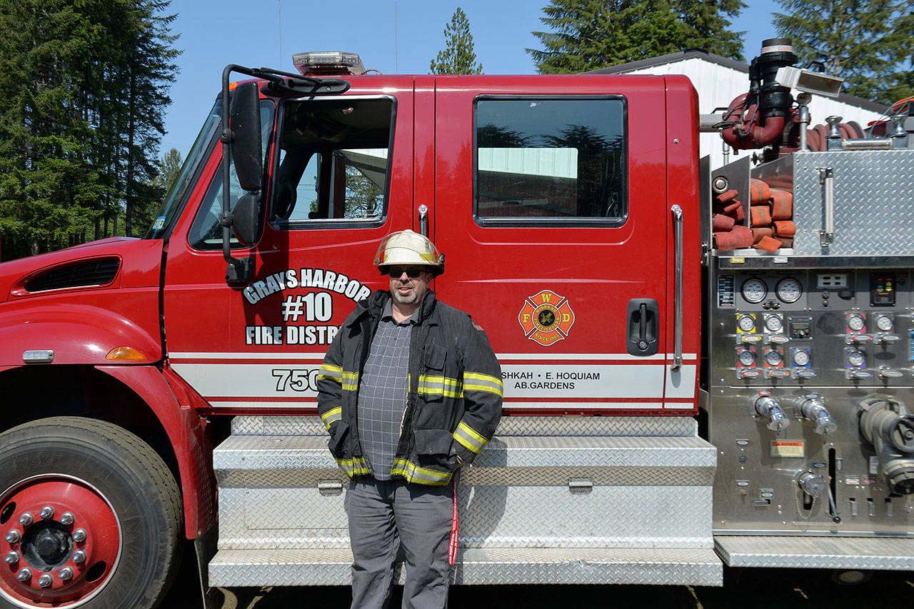 Louis Krauss | Grays Harbor News Group                                Mike Pauley, the 2019 Firefighter of the Year, poses with a fire truck for Fire District 10 in Wishkah Valley.