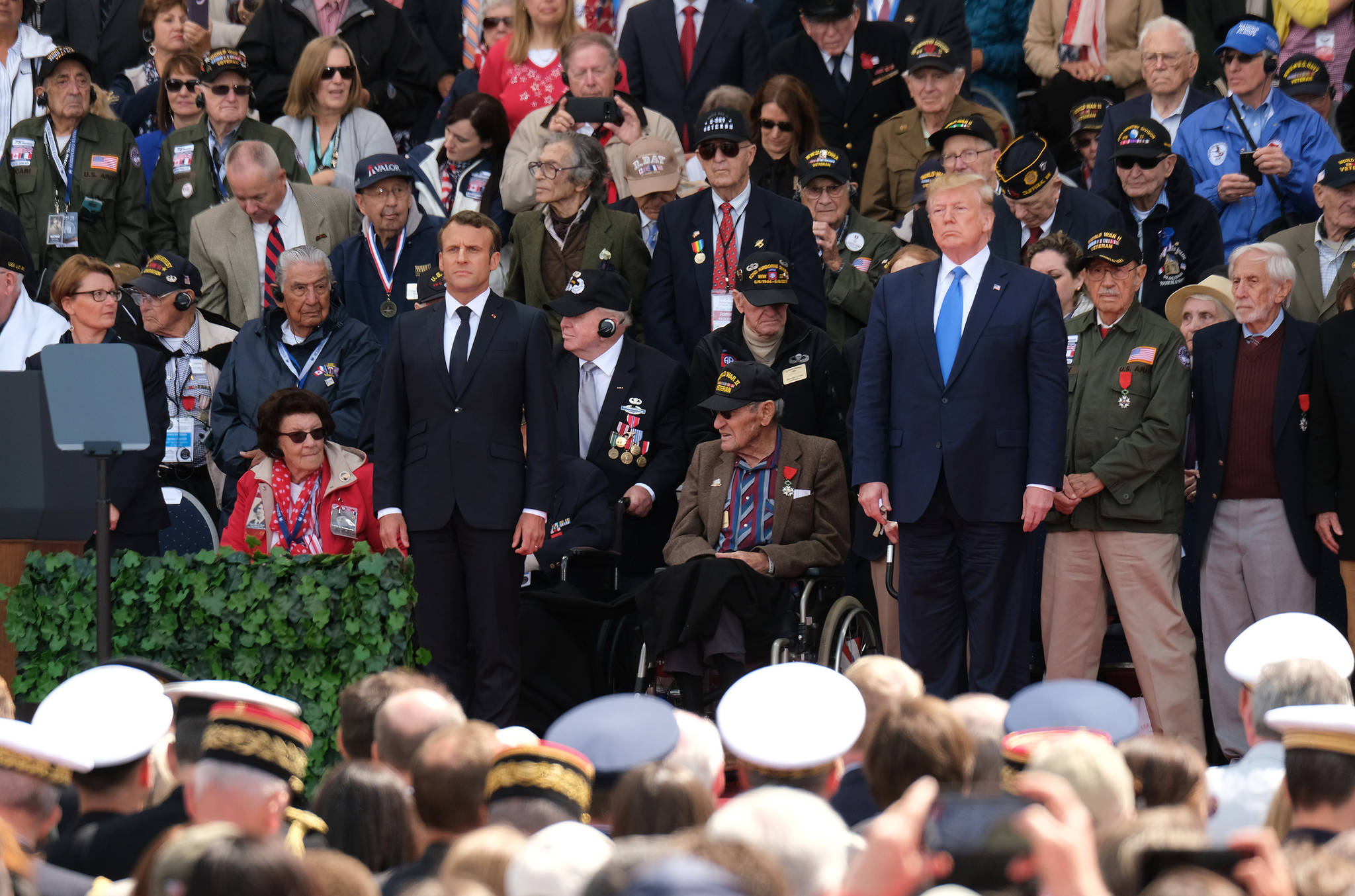 U.S. President Donald Trump and French President Emmanuel Macron stand as American Battle of Normandy veterans and family members look on during the main ceremony to mark the 75th anniversary of the World War II Allied D-Day invasion of Normandy at Normandy American Cemetery Thursday near Colleville-Sur-Mer, France. (Sean Gallup/Getty Images/TNS)