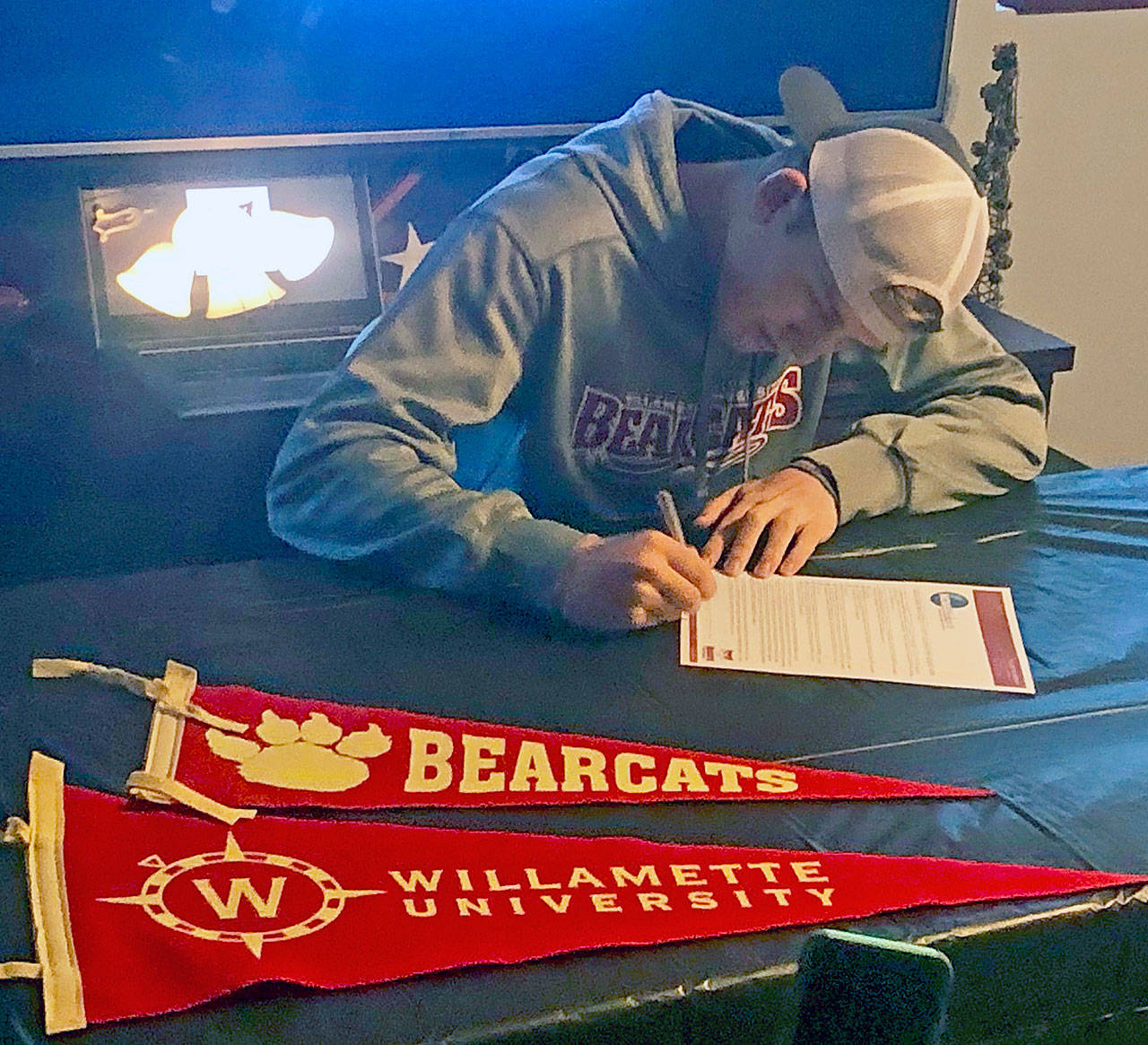 Ocosta Wildcats wide receiver Jayden Matthews signs a National Letter of Intent to play football for the Willamette University Bearcats this fall. (Submitted photo)