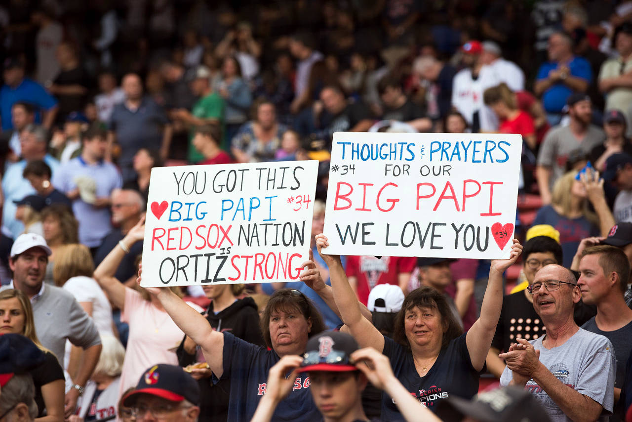 Fans hold up signs showing support for former Red Sox player David Ortiz prior to the start of the game against the Texas Rangers at Fenway Park on June 10, 2019 in Boston, Mass. Ortiz was shot in the back while at a club in the Dominican Republic. He underwent surgery and the Red Sox are transporting him back to Boston. (Kathryn Riley | Getty Images/TNS)