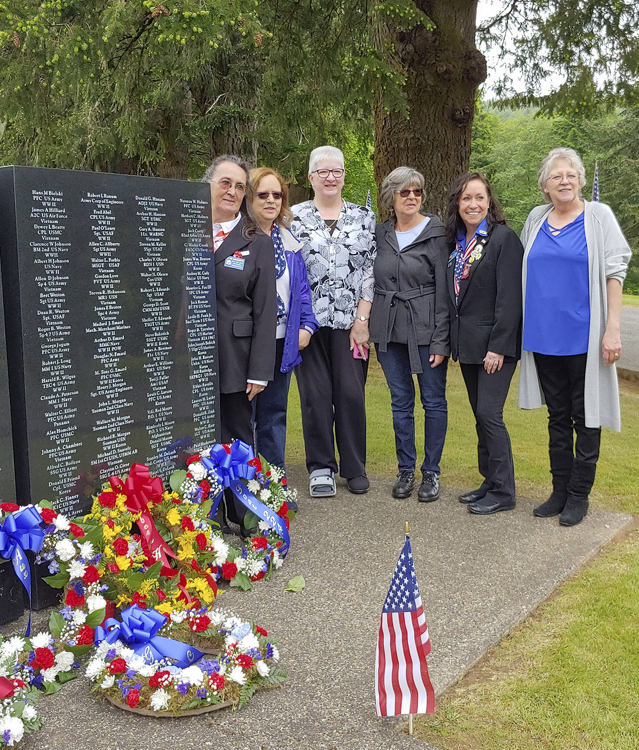 Courtesy photo                                VFW Auxiliary members participating in the Memorial Day service May 27 included, from left: Jo Ann Wadsworth, Aberdeen Auxiliary president; Joan Murphy Nihart, Washington State Auxiliary guard; Lois Daly; Pam Burns; and Kerry Mumper. Aberdeen VFW Commander Anthony Magri presented the meaning of the POW table during the service at Fern Hill Cemetery.