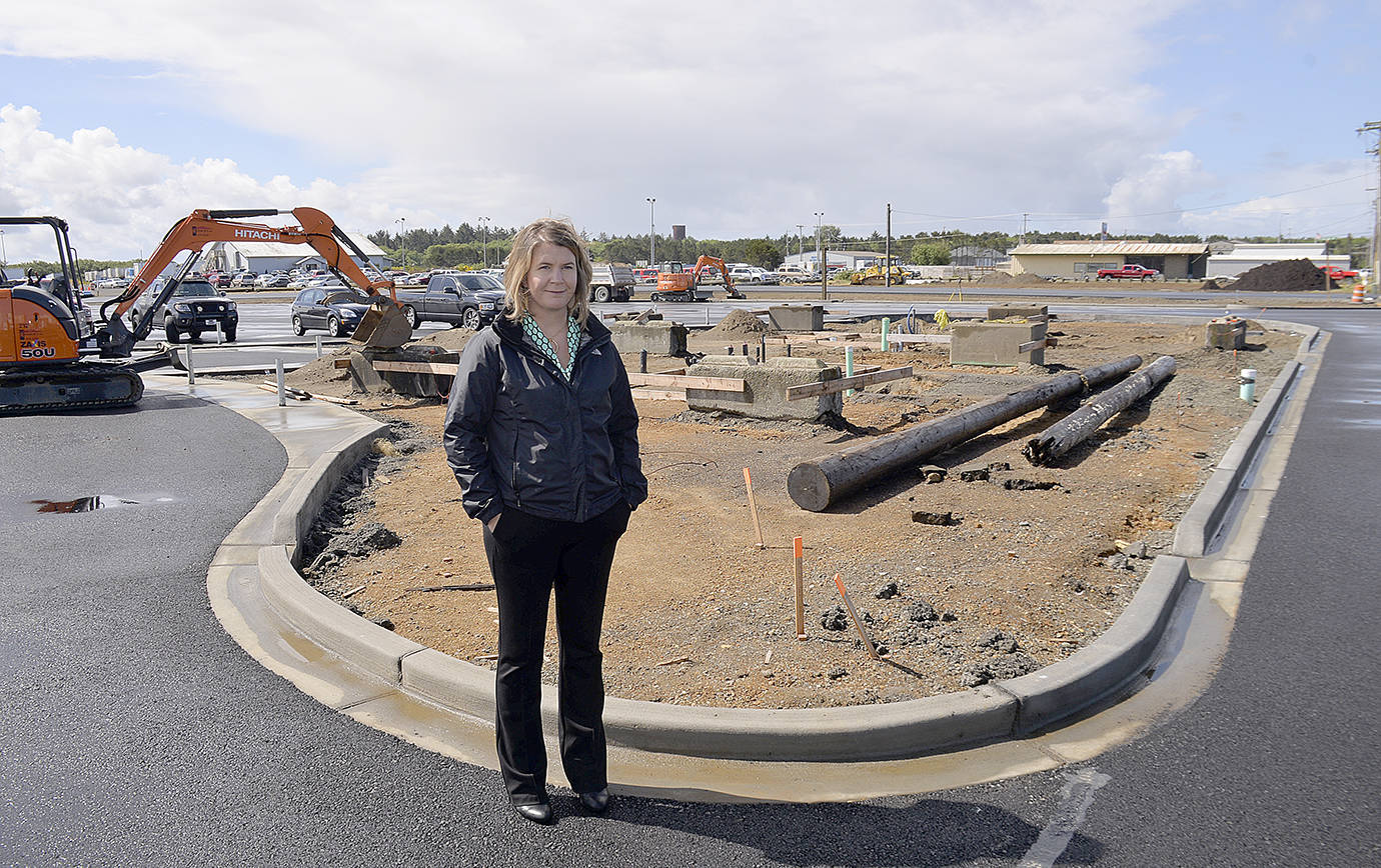 DAN HAMMOCK | GRAYS HARBOR NEWS GROUP                                Westport Marina Business Manager Molly Bold stands on the freshly-paved surface of the Westport boat launch parking area. Behind her construction continues on new restrooms and a fish cleaning station.