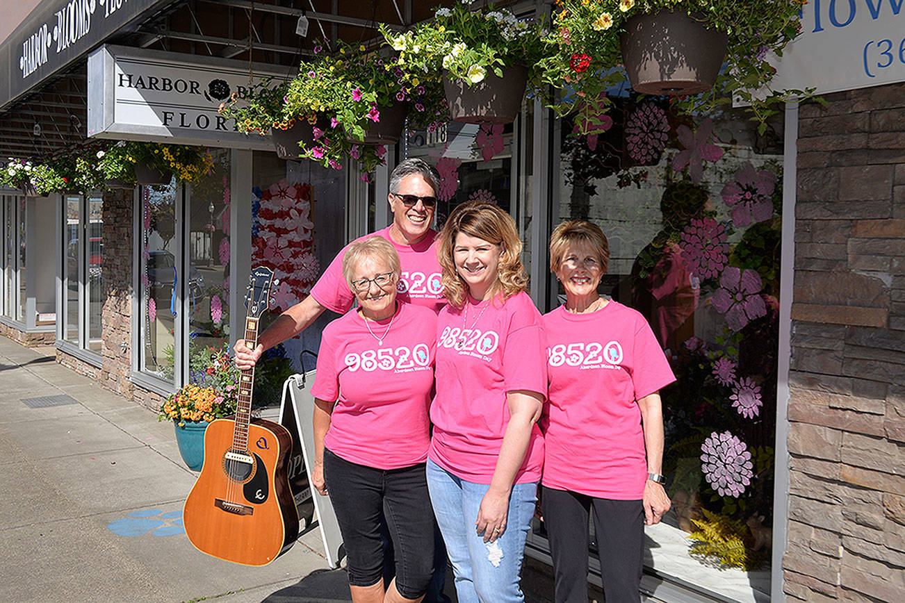 (Louis Krauss | Grays Harbor News Group) Bobbi McCracken, left, stands next to Downtown Aberdeen Association Executive Director Wil Russoul, Harbor Blooms owner Sheril Woodruff, and Bette Worth in front of the Harbor Blooms store.