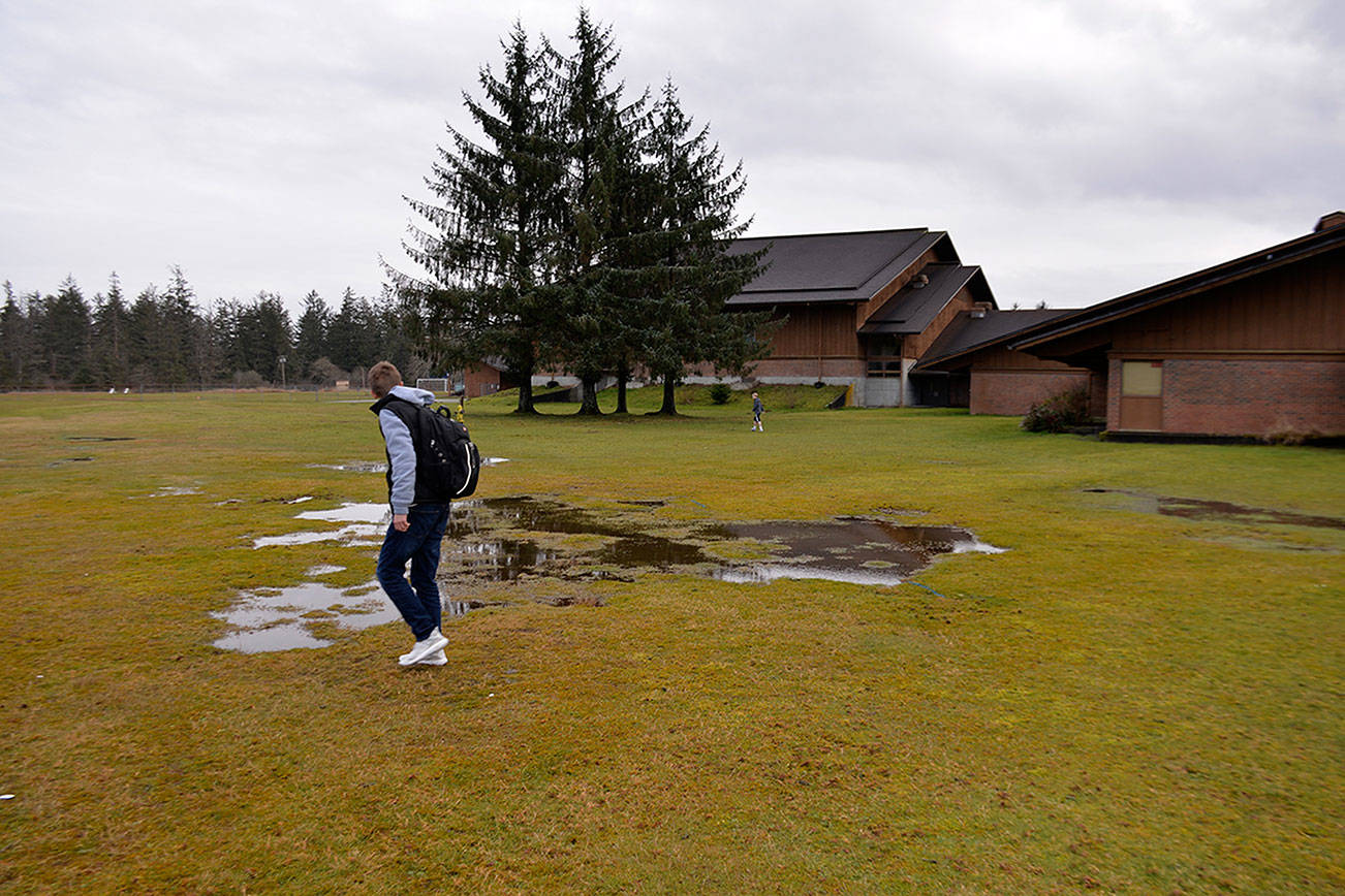 (Louis Krauss | Grays Harbor News Group) A Miller Junior High student walks across the field next to Miller, the area where a portable classroom to expand and host sixth-graders is expected to go.