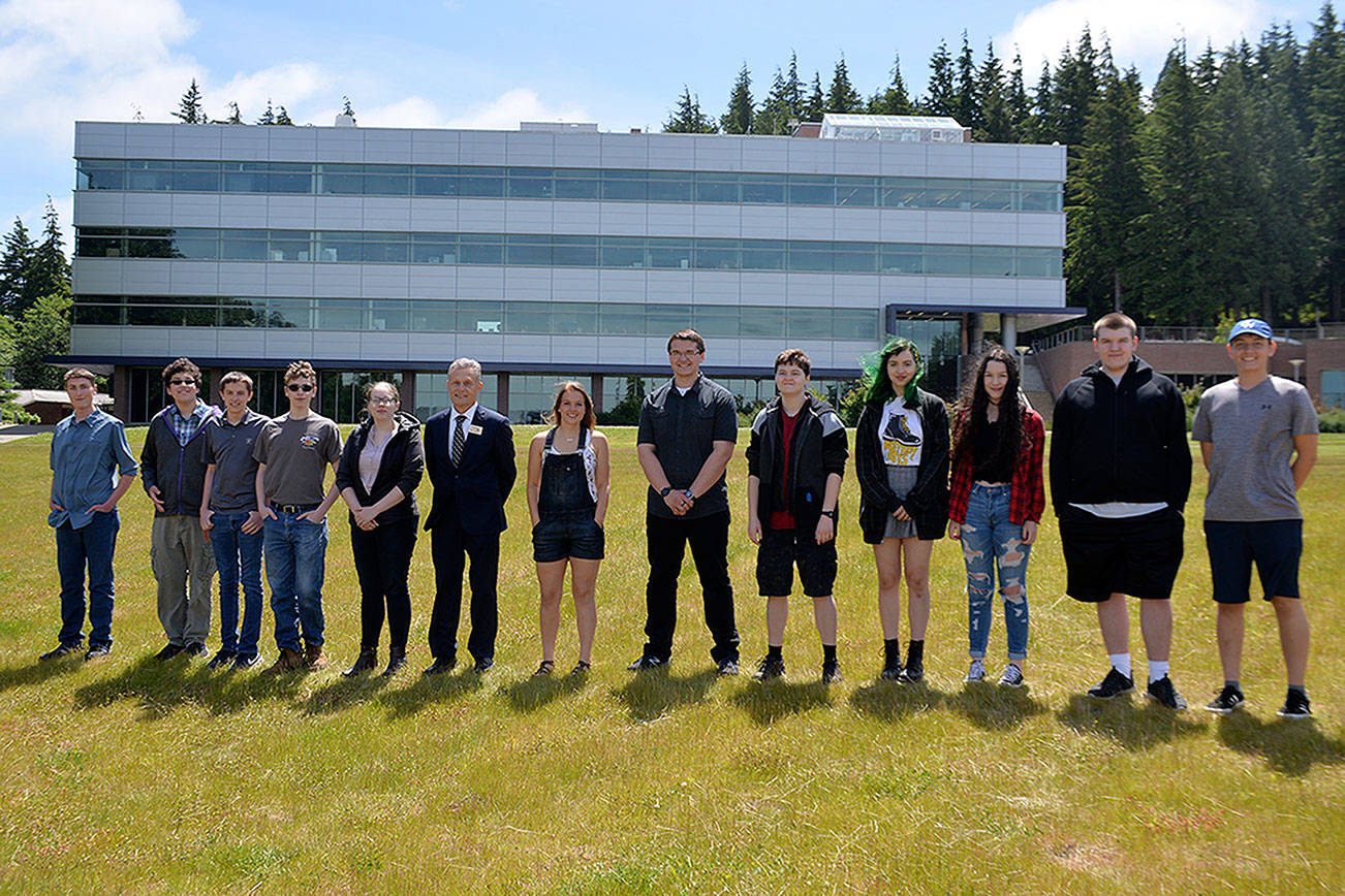 (Louis Krauss | Grays Harbor News Group) Grays Harbor College’s 13 top scholars stand for a photo with President Jim Minkler, sixth from left. They are, from left to right: Michael Urbaniak, Lucius Veiga, Nolan Palmer, Joshua Latimer, Raven A. Stoney, Minkler, Kamryn Adkins, Dakota Ross, Adrian Greenway, Sierra Templeton, Zoe Templeton, Cain McCulloug, Kaiden Coty, and Emma Nitahara (not pictured).