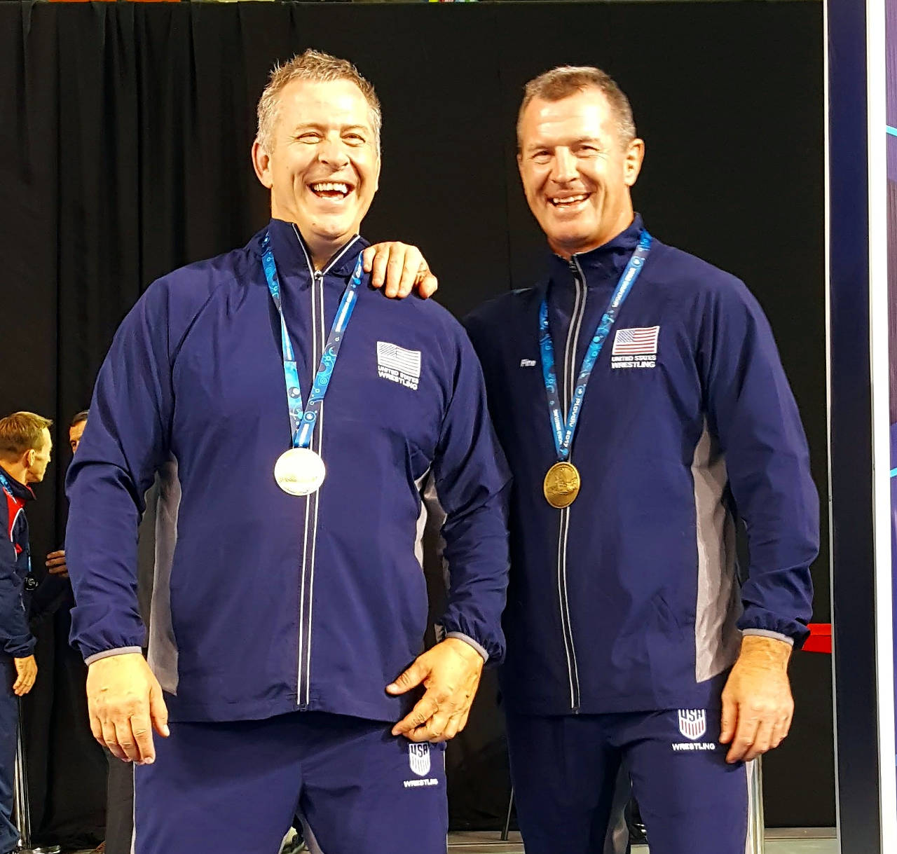 Kevin Pine, left, stands with his brother, Phillip Pine, after winning bronze medals at the Veteran World wrestling tournament in Plovdiv, Bulgaria. Kevin Pine was named Grays Harbor College head women’s wrestling coach in early May. (Submitted photo)