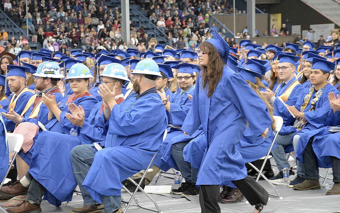 photos by DAN HAMMOCK | GRAYS HARBOR NEWS GROUP                                Grays Harbor College Outstanding Student of 2019 Mary Valentine approaches the stage to claim her award at the college’s 89th commencement ceremony Friday at Stewart Field in Aberdeen. Valentine studied marine biology and received her Associate in Arts degree.