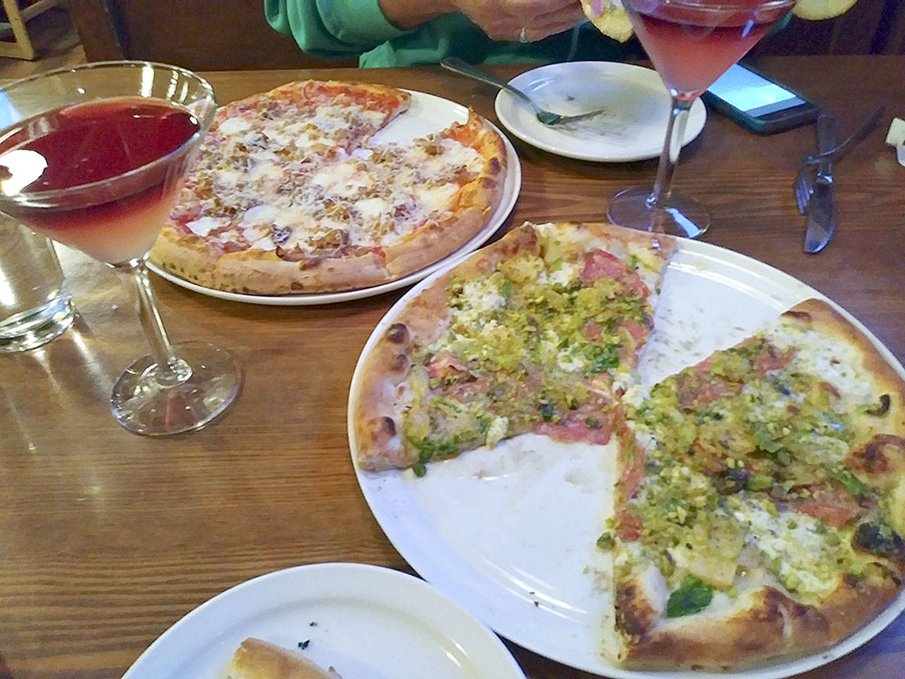 Pizza from Fat Olives: The pie on the right, the Belgio Dolce, features a white sauce base, mozzarella, pecorino romano, oregano, shaved fire-roasted brussel sprouts, calabrian chili oil, Molinari soppressata, local honey and crushed pistachios. One of the best pizzas ever and featured on the Food Networks Diners, Drive-ins and Dives.