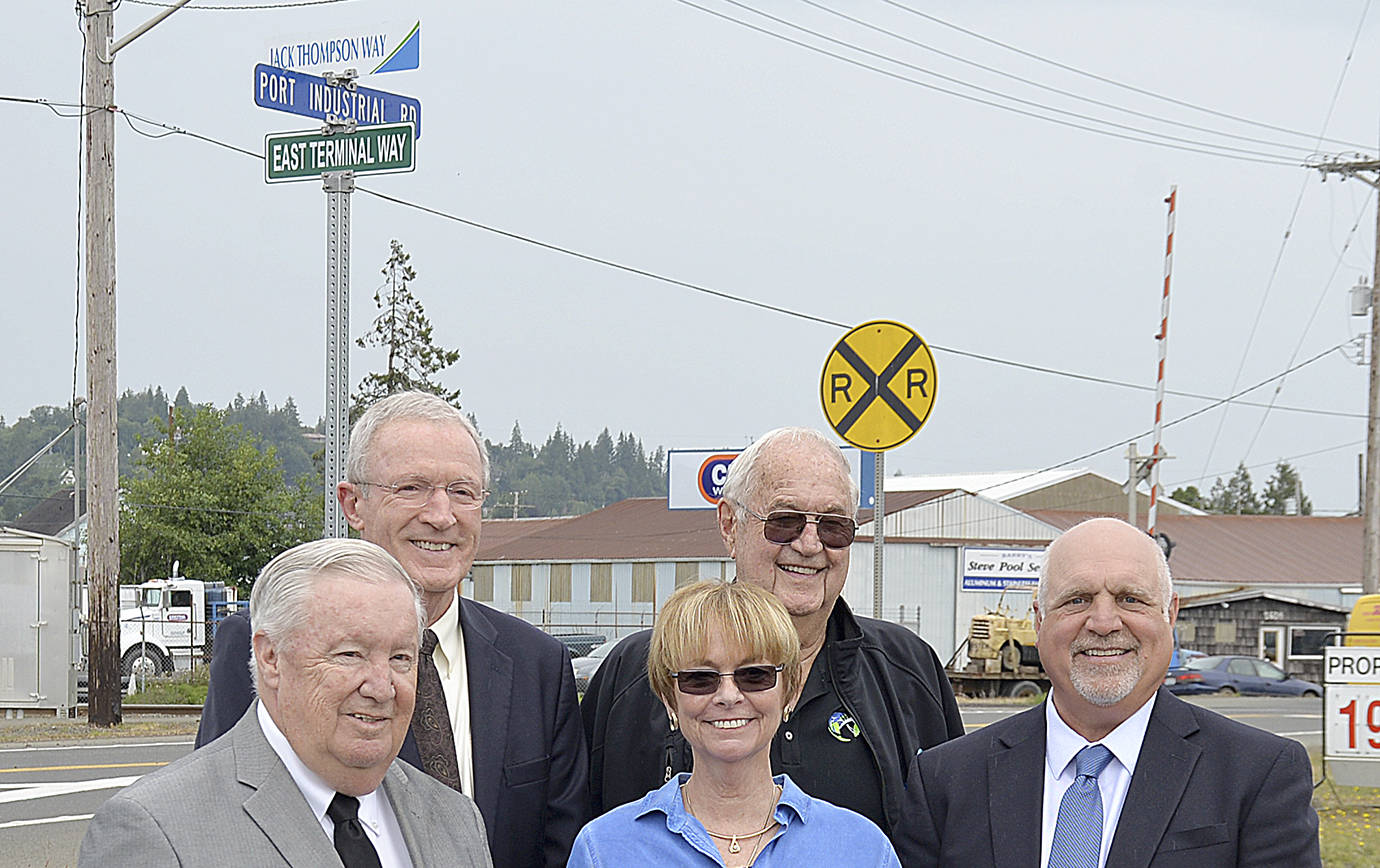 DAN HAMMOCK | GRAYS HARBOR NEWS GROUP                                From left, Port of Grays Harbor Commission President Stan Pinnick, Port Commissioner Tom Quigg, Trish Thompson, former commissioner Chuck Caldwell, and Port Commissioner Phil Papac stand beneath the sign designating East Terminal Way as Jack Thompson Way.