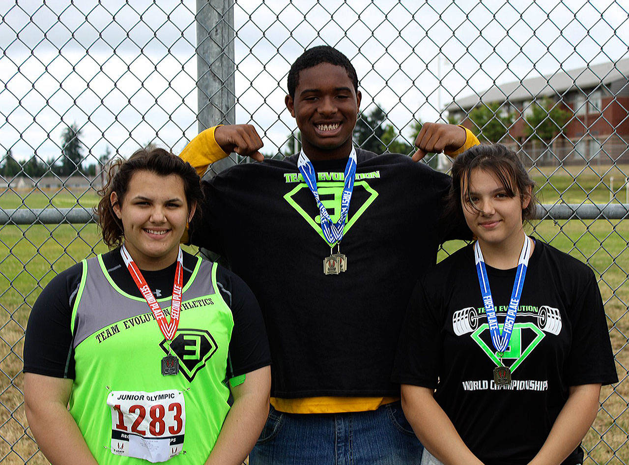 From left: Team Evolution’s Mataya Straka, JaBron Brooks and Tyara Straka pose with their medals at the USATF Region 13 Junior Olympics on July 7. (Submitted photo)