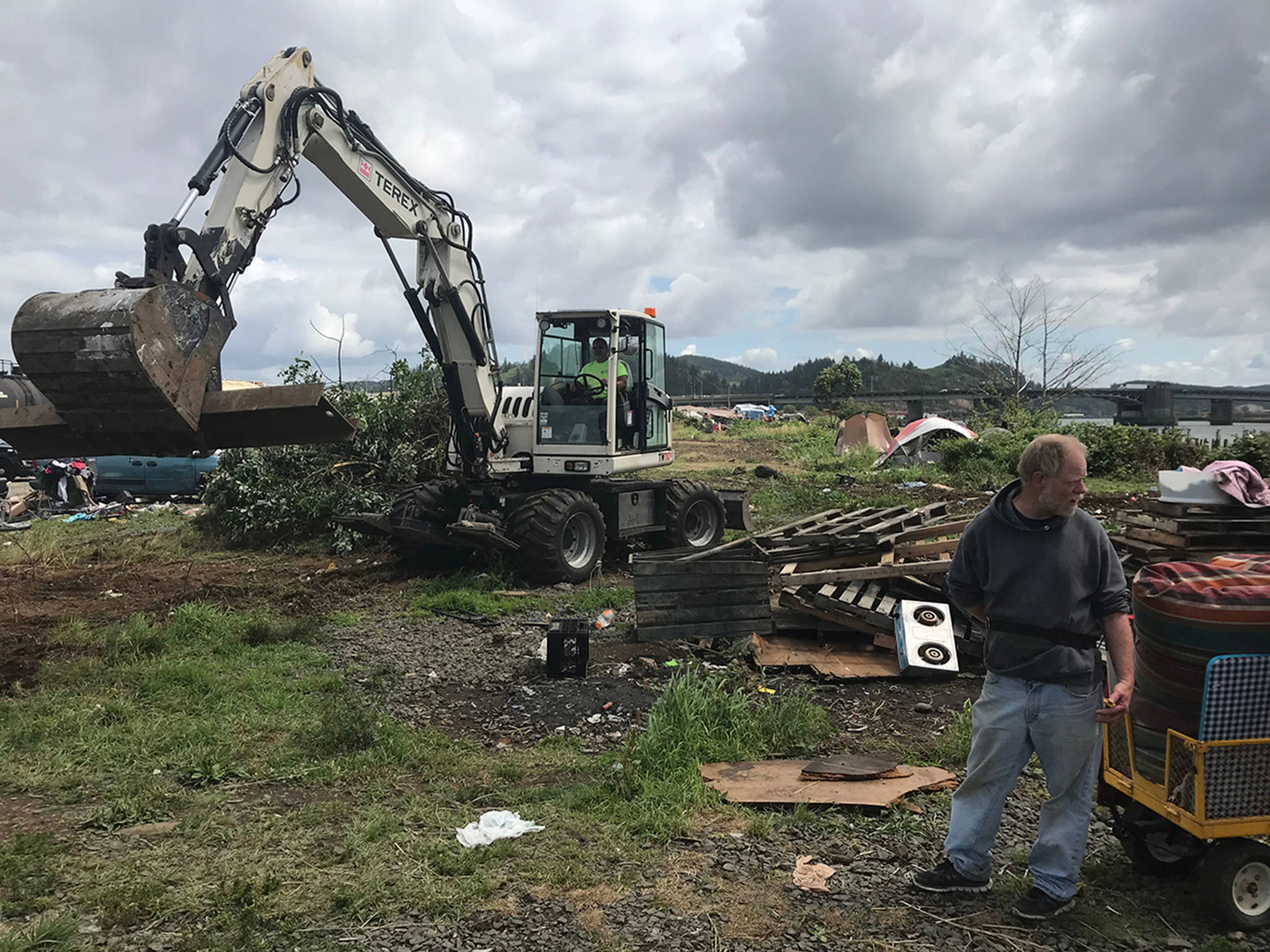 Louis Krauss | Grays Harbor News Group                                James Horack, 54, starts pulling a cart filled with blankets, furniture and other belongings before his shack gets leveled by Aberdeen city workers.