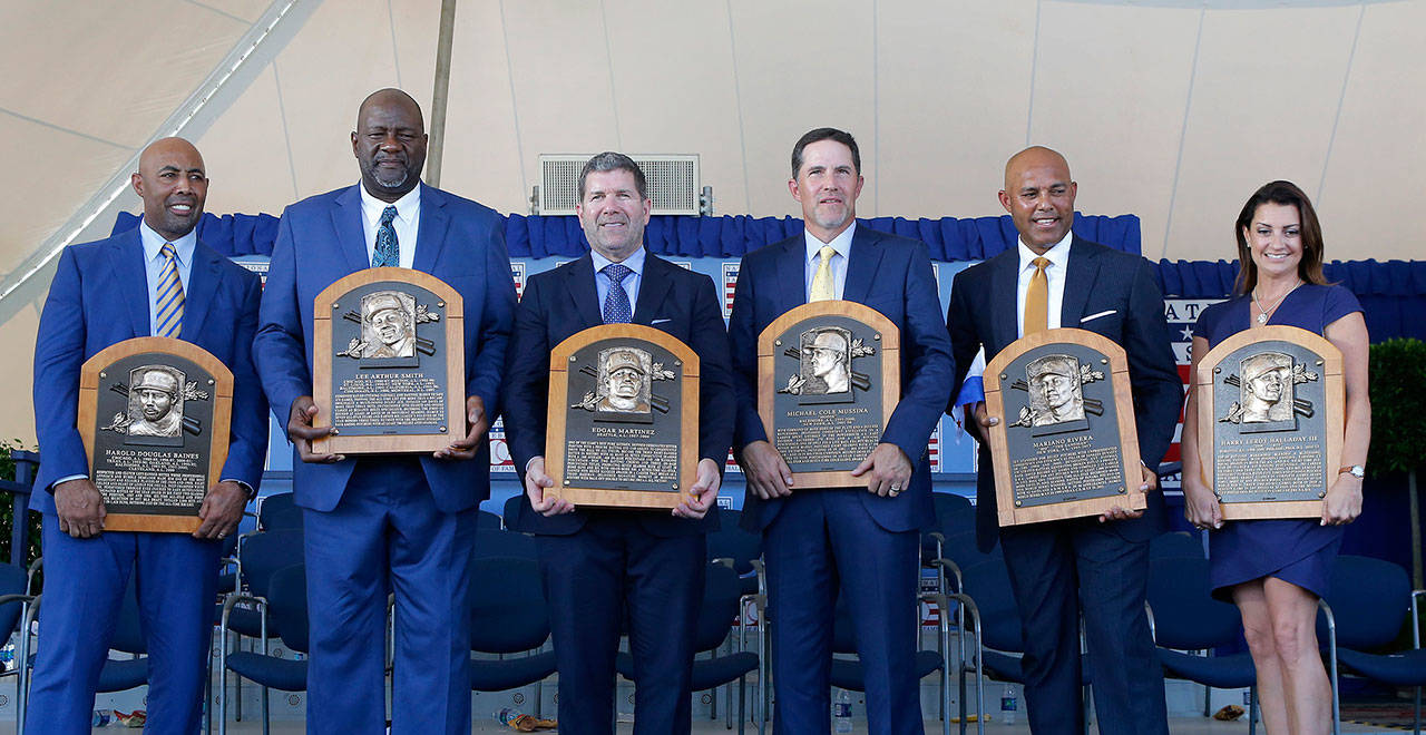 Inductees (from left) Harold Baines, Lee Smith, Edgar Martinez, Mike Mussina, Mariano Rivera and Brandy Halladay, wife the late Roy Halladay, pose with their plaques during the Baseball Hall of Fame induction ceremony at Clark Sports Center on July 21, 2019 in Cooperstown, N.Y. (Jim McIsaac/Getty Images/TNS)