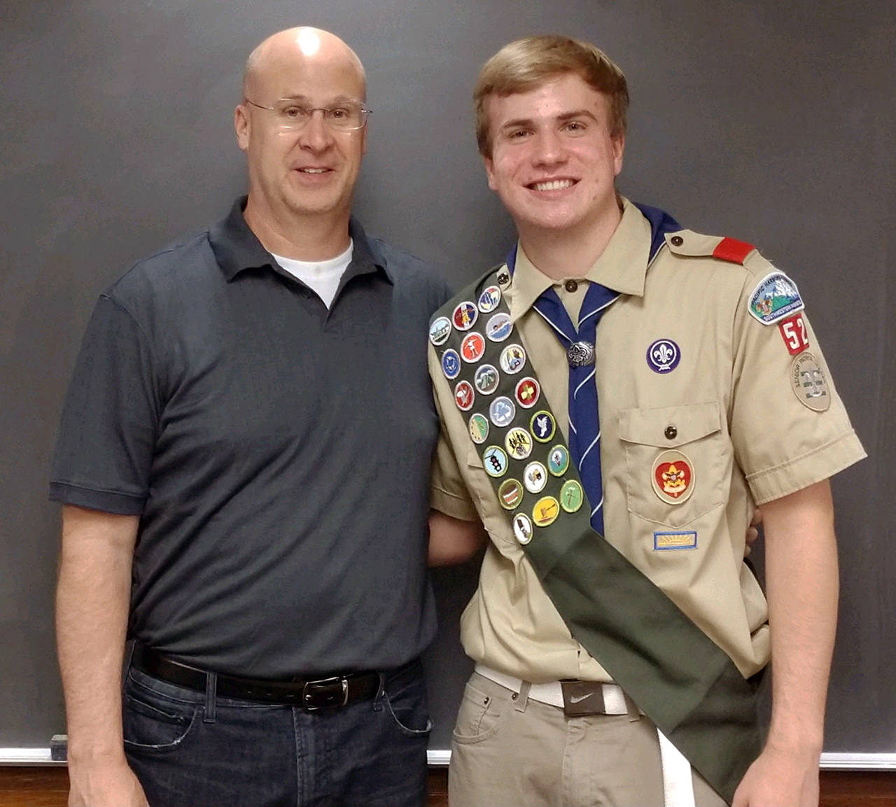 Courtesy photo                                Nick Farrer, the son of Ryan and Erin Farrer of Aberdeen, earned his Eagle Scout award this past week. He’s pictured here with his dad. Nick, a member of Troop 4052, graduated from Aberdeen High School this spring with honors. His Eagle project involved veterans recognition at Forest Hill Cemetery in Cosmopolis.