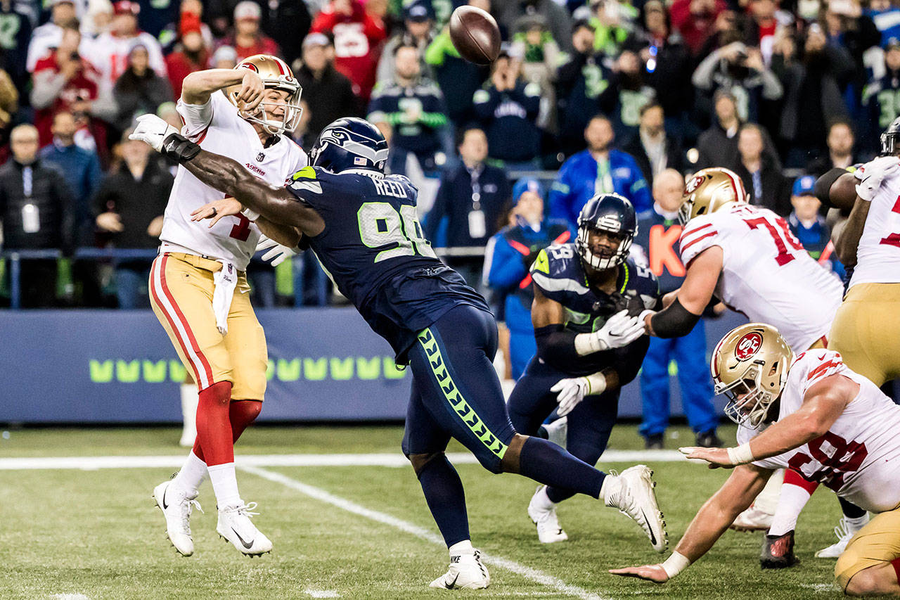 Seattle Seahawks defensive tackle Jarran Reed pressures San Francisco 49ers quarterback Nick Mullens during a game on Sunday, Dec. 2, 2018. Reed was suspended by the NFL on Monday. (Bettina Hansen/Seattle Times/TNS)