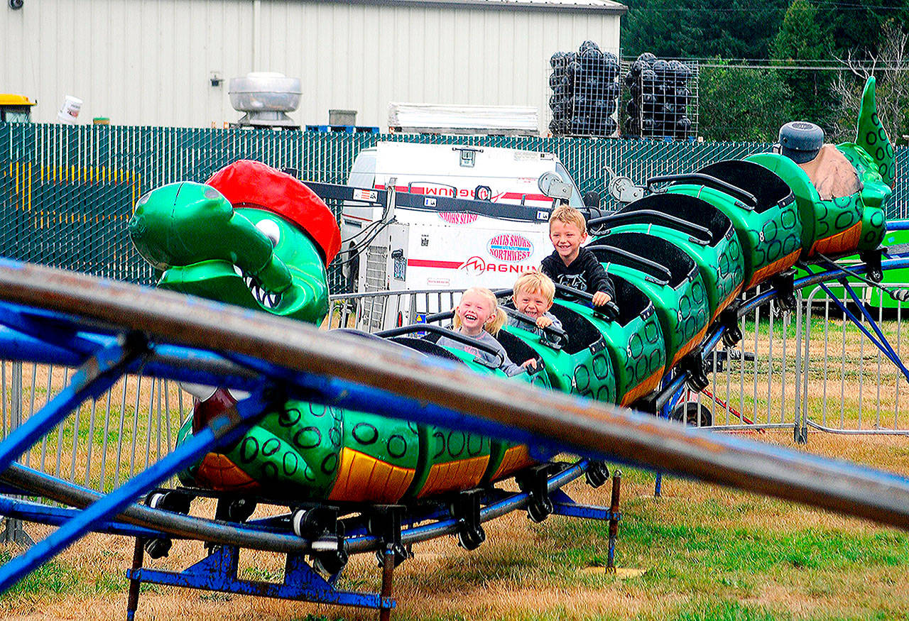 Children ride the dragon rollercoaster at the Grays Harbor County Fair on Friday. (Photos by Hasani Grayson | The Daily World)