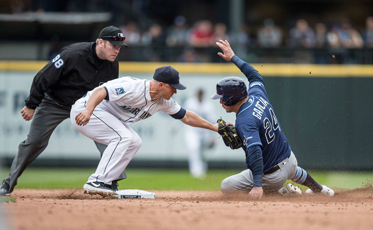 Third baseman Kyle Seager (15) of the Seattle Mariners tags out a stealing Avisail Garcia (24) of the Tampa Bay Rays at second base during the eighth inning on Sunday, Aug. 11, 2019 at T-Mobile Park in Seattle, Wash. The Rays won the game 1-0. (Stephen Brashear/Getty Images/TNS)