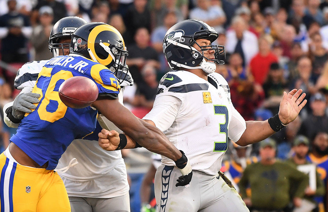 Los Angeles Rams linebacker Dante Fowler forces a fumble on Seattle Seahawks quarterback Russell Wilson in the fourth quarter on Sunday, Nov. 11, 2018 at the Coliseum in Los Angeles, Calif. Fowler recovered the ball. (Wally Skalij/Los Angeles Times/TNS)