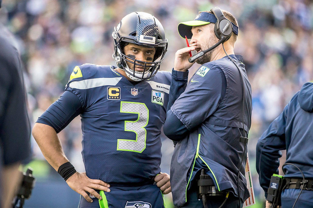 Seattle Seahawks quarterback Russell Wilson talks with offensive coordinator Brian Schottenheimer during the game against the Los Angeles Chargers on Sunday, Nov. 4, 2018 at CenturyLink Field in Seattle, Wash. (Bettina Hansen/Seattle Times/TNS)