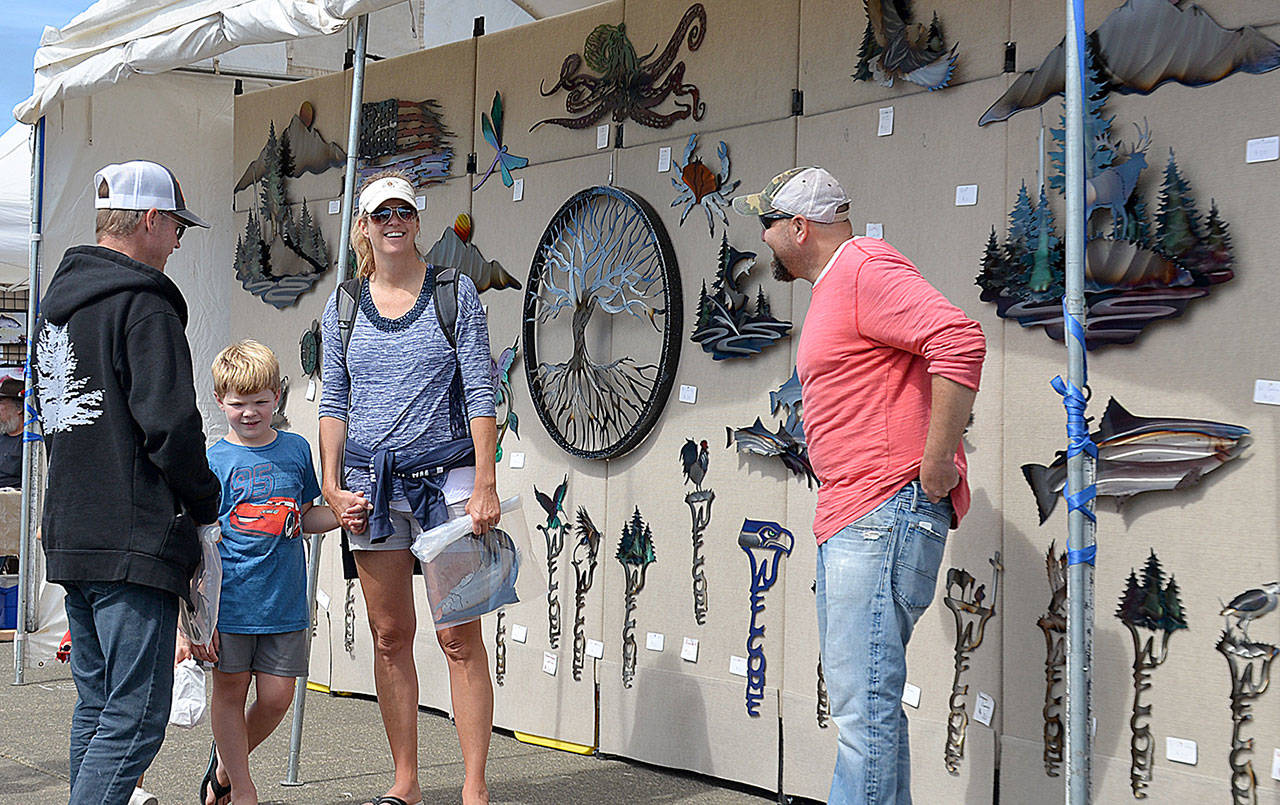 DAN HAMMOCK | GRAYS HARBOR NEWS GROUP                                Among the more than 60 vendors was Eric Langeliers of Springfield, Oregon, at right, who did a brisk business selling his metal art.