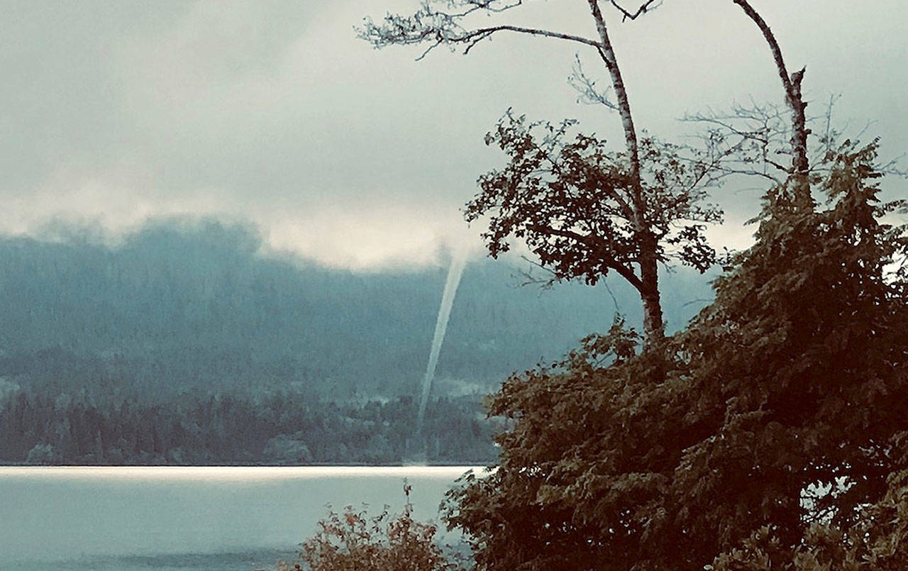 PHOTO BY MARLICE GULACSIK                                Marlice Gulacsik of Quinault shot this photo of a waterspout over Lake Quinault from her cabin Aug. 11. “It touched down at the water in front of July Creek Beach and headed north,” said Gulacsik.