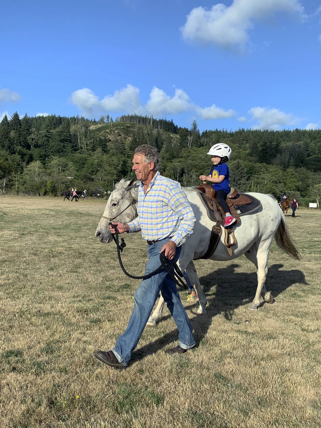 Kat Bryant | Grays Harbor News Group                                Hope From Horses President Jay Rosenbach leads one of his horses, “Kid,” carrying Connolly Mattoon, 3, during the carnival at Immanuel Baptist Church on Saturday.
